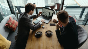 Two young businessman having a successful meeting at restaurant.